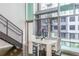 Open-concept living room with large windows, a staircase, and views of the city at 845 Spring Street Northwest Nw St # 307, Atlanta, GA 30308