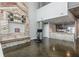 Open-concept living space features concrete floors, a modern fireplace, and an adjacent kitchen area at 845 Spring Street Northwest Nw St # 307, Atlanta, GA 30308