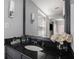 Elegant bathroom with a granite countertop vanity, decorative lighting, and a large mirror at 195 14Th St # 902, Atlanta, GA 30309
