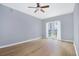Spacious bedroom with hardwood floors, a ceiling fan, and access to a private balcony at 195 14Th St # 902, Atlanta, GA 30309