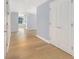 Hallway with hardwood floors and view into an open concept living space at 195 14Th St # 902, Atlanta, GA 30309