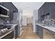 Modern kitchen with stainless steel appliances, granite countertops, mosaic backsplash, and sleek gray cabinetry at 195 14Th St # 902, Atlanta, GA 30309