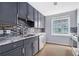 Well-appointed kitchen featuring gray cabinets, stainless steel appliances, and a stylish mosaic backsplash at 195 14Th St # 902, Atlanta, GA 30309