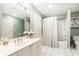 Neutral bathroom featuring shower with tub, white vanity, and decorative mirror at 211 Colonial Homes Nw Dr # 2501, Atlanta, GA 30309