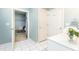 Bathroom with white tiled floors, access to the walk-in closet, and natural light at 211 Colonial Homes Nw Dr # 2501, Atlanta, GA 30309