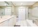 Bright bathroom with a glass shower, soaking tub, double sink vanity, and tiled flooring at 211 Colonial Homes Nw Dr # 2501, Atlanta, GA 30309