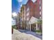 Exterior of condominium building featuring brick facade, windows, and a manicured landscape at 211 Colonial Homes Nw Dr # 2501, Atlanta, GA 30309