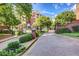 Gated community entrance with mature trees, brick facade, and professionally manicured landscaping at 211 Colonial Homes Nw Dr # 2501, Atlanta, GA 30309