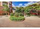 Exterior of condominium building with landscaped traffic circle and mature trees at 211 Colonial Homes Nw Dr # 2501, Atlanta, GA 30309