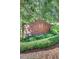 Condominium signage, featuring lush landscaping and brick architecture at 211 Colonial Homes Nw Dr # 2501, Atlanta, GA 30309