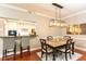 Bright dining area open to the kitchen, featuring hardwood floors, pendant lighting and bar stool seating at 211 Colonial Homes Nw Dr # 2501, Atlanta, GA 30309