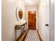 Cozy entryway with a modern runner rug, decorative table and mirror at 211 Colonial Homes Nw Dr # 2501, Atlanta, GA 30309