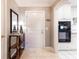 Inviting entryway with modern mirror, hall table and kitchen access at 211 Colonial Homes Nw Dr # 2501, Atlanta, GA 30309