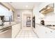 Bright kitchen with white cabinets, stainless steel appliances, granite countertops and white tile floors at 211 Colonial Homes Nw Dr # 2501, Atlanta, GA 30309