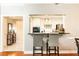 View from dining area of kitchen with breakfast bar and white cabinets at 211 Colonial Homes Nw Dr # 2501, Atlanta, GA 30309