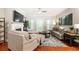 Living room featuring a ceiling fan, neutral paint and a fireplace at 211 Colonial Homes Nw Dr # 2501, Atlanta, GA 30309