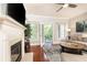Relaxing living room with fireplace, balcony, hardwood floors, and natural light at 211 Colonial Homes Nw Dr # 2501, Atlanta, GA 30309