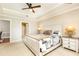 Main bedroom featuring a tray ceiling, neutral carpet, and connecting ensuite at 211 Colonial Homes Nw Dr # 2501, Atlanta, GA 30309