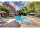Community pool area featuring lounge chairs and umbrella-covered tables for relaxing and socializing at 211 Colonial Homes Nw Dr # 2501, Atlanta, GA 30309