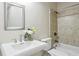 Bathroom featuring tile tub/shower combo, pedestal sink, and modern fixtures at 345 Alderwood Ln, Sandy Springs, GA 30328