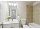 Bathroom featuring a tile shower and tub combo, vanity with sink, and modern lighting at 345 Alderwood Ln, Sandy Springs, GA 30328