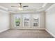 Bright bedroom featuring white trim, large windows, and neutral carpet at 345 Alderwood Ln, Sandy Springs, GA 30328