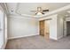 Bedroom with neutral carpet, white trim, barn door, and tray ceiling at 345 Alderwood Ln, Sandy Springs, GA 30328