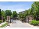 Gated entrance to a residential community, brick pillars, and lush landscaping at 345 Alderwood Ln, Sandy Springs, GA 30328
