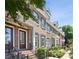 Brick townhouses with manicured landscaping, black iron railings, and covered entryways at 345 Alderwood Ln, Sandy Springs, GA 30328