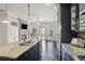 Open concept kitchen features an island, granite countertops, stainless steel appliances and views into the living room at 345 Alderwood Ln, Sandy Springs, GA 30328