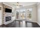 Bright living room boasts a brick fireplace, built-in shelves, dark wood floors, and access to the outdoor deck at 345 Alderwood Ln, Sandy Springs, GA 30328