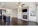 Open concept living space features dark wood flooring, a brick fireplace, stainless steel appliances, and an island at 345 Alderwood Ln, Sandy Springs, GA 30328