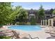 Community pool area with lounge chairs, pergola, and well-maintained landscaping at 345 Alderwood Ln, Sandy Springs, GA 30328