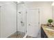 Tiled shower with glass doors and stone flooring at 345 Alderwood Ln, Sandy Springs, GA 30328