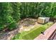 The backyard features mature trees and a small storage shed with an artificial turf area at 350 Paces Dr, Lithia Springs, GA 30122
