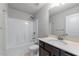 Clean bathroom with shower-tub combo, vanity with dark cabinets and a large mirror at 350 Paces Dr, Lithia Springs, GA 30122