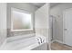 The bathroom features a garden tub, a tiled floor and walls, plus a glass-enclosed shower at 350 Paces Dr, Lithia Springs, GA 30122