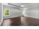 Bright bedroom features hardwood floors, tray ceiling, and double windows at 350 Paces Dr, Lithia Springs, GA 30122