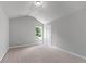 Bright bedroom featuring a large window, neutral carpet, and ample natural light at 350 Paces Dr, Lithia Springs, GA 30122