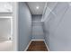 Walk-in closet with wood flooring, gray walls, white shelving and plenty of space for storage at 350 Paces Dr, Lithia Springs, GA 30122
