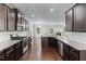 This spacious kitchen is equipped with granite counters, stainless appliances and dark wood cabinets at 350 Paces Dr, Lithia Springs, GA 30122