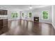Open-concept living room with fireplace, wood floors, light gray walls and lots of natural light at 350 Paces Dr, Lithia Springs, GA 30122