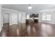Spacious open-concept living area with hardwood floors, chandelier, and view into kitchen at 350 Paces Dr, Lithia Springs, GA 30122