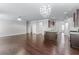 The living room has wood floors, recessed lighting, a chandelier and is open to the kitchen at 350 Paces Dr, Lithia Springs, GA 30122