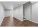 Open living area features wood-look tile flooring and staircase to another level at 350 Paces Dr, Lithia Springs, GA 30122