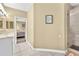 A bathroom with granite countertops, tile floors, and an adjacent shower at 827 Fraser Se St, Atlanta, GA 30315