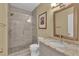 This bathroom has a glass shower with a rain shower head, granite countertops, and tile floors at 827 Fraser Se St, Atlanta, GA 30315