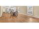 Open dining area with hardwood floors, large windows, and a view into the modern kitchen at 827 Fraser Se St, Atlanta, GA 30315