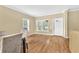 Welcoming entryway with hardwood floors, natural light from large windows, and a decorative front door at 827 Fraser Se St, Atlanta, GA 30315