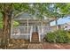 Charming home featuring a large front porch, well-maintained landscaping, and inviting curb appeal at 827 Fraser Se St, Atlanta, GA 30315